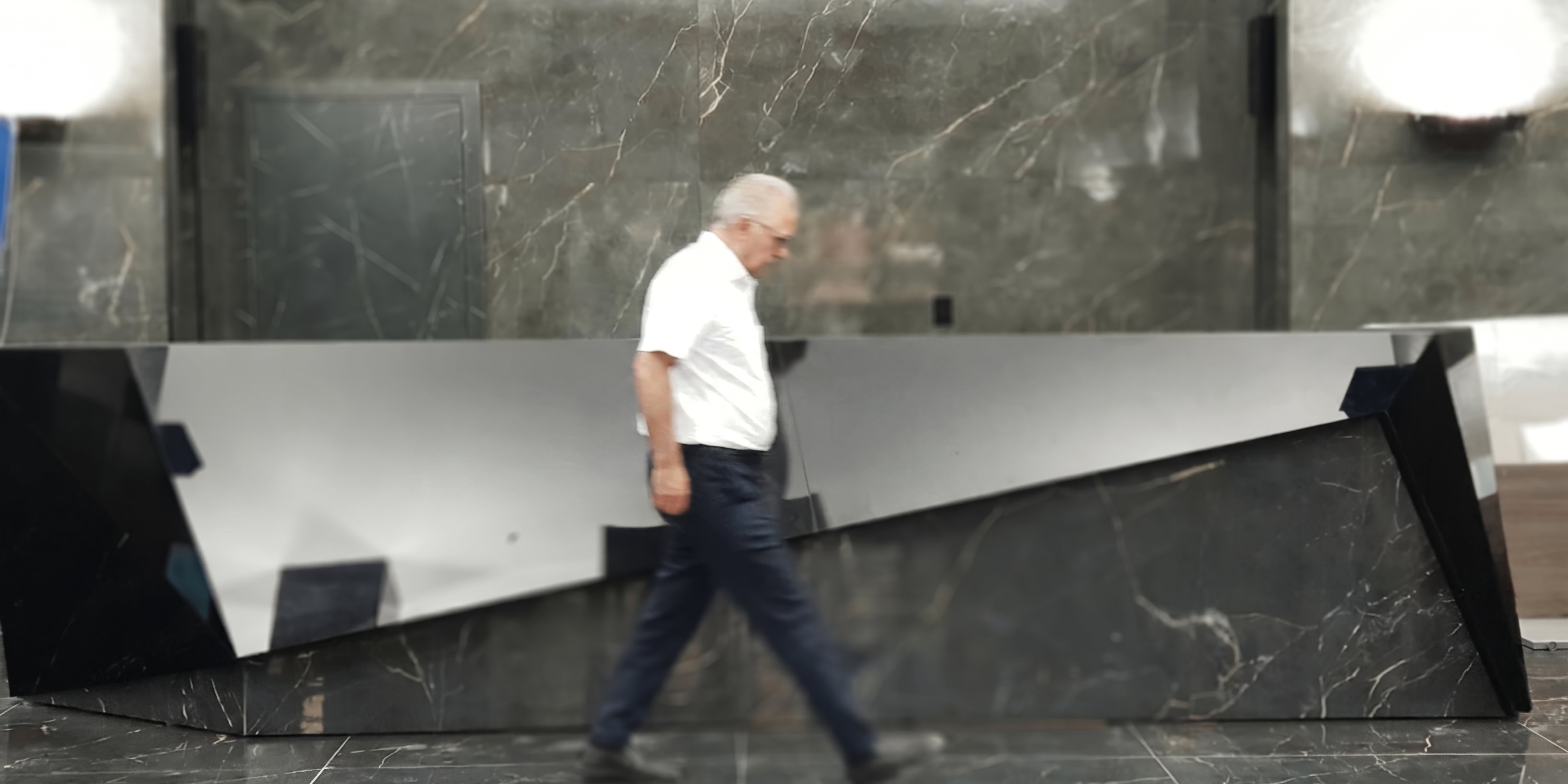 Prisma Noir in Tehran lobby — passerby for scale